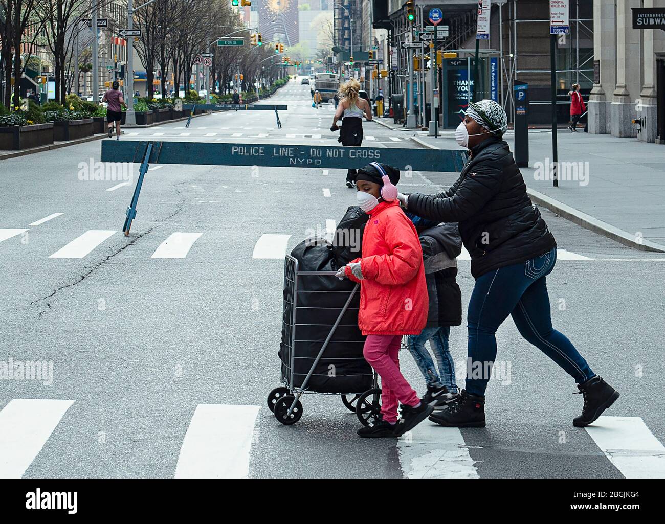 A family crossing Park Avenue South during the COVID-19 pandemic in New York City. Stock Photo