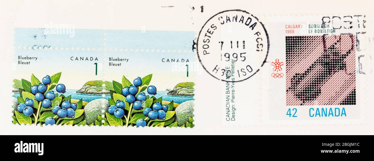SEATTLE WASHINGTON - April 20, 2020: Close up of envelope with Canadian  stamps and Canada Post postmark of 1995. Scott # 1349 and 1131 Stock Photo