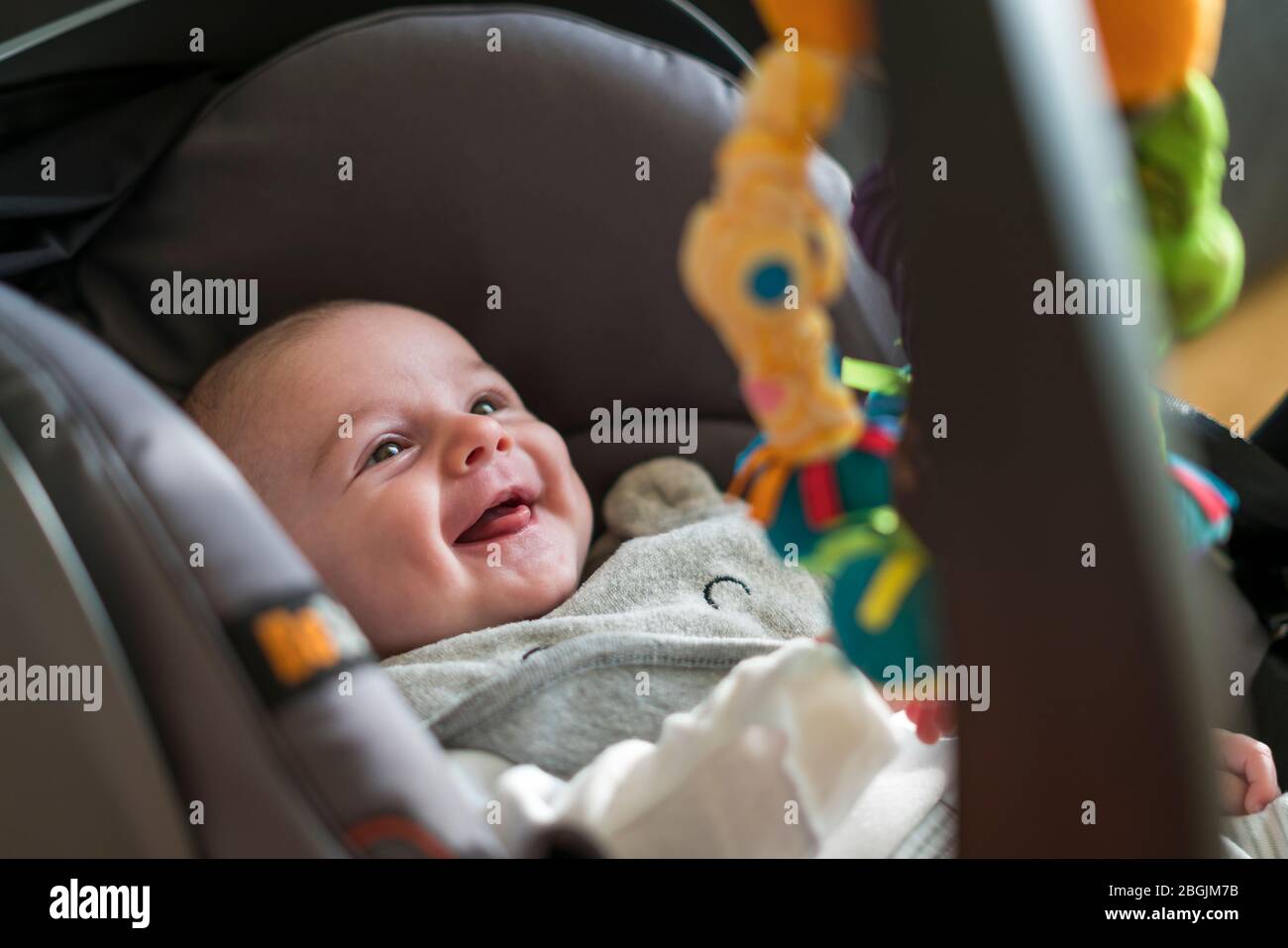 High angle view of smiling baby in car seat Stock Photo