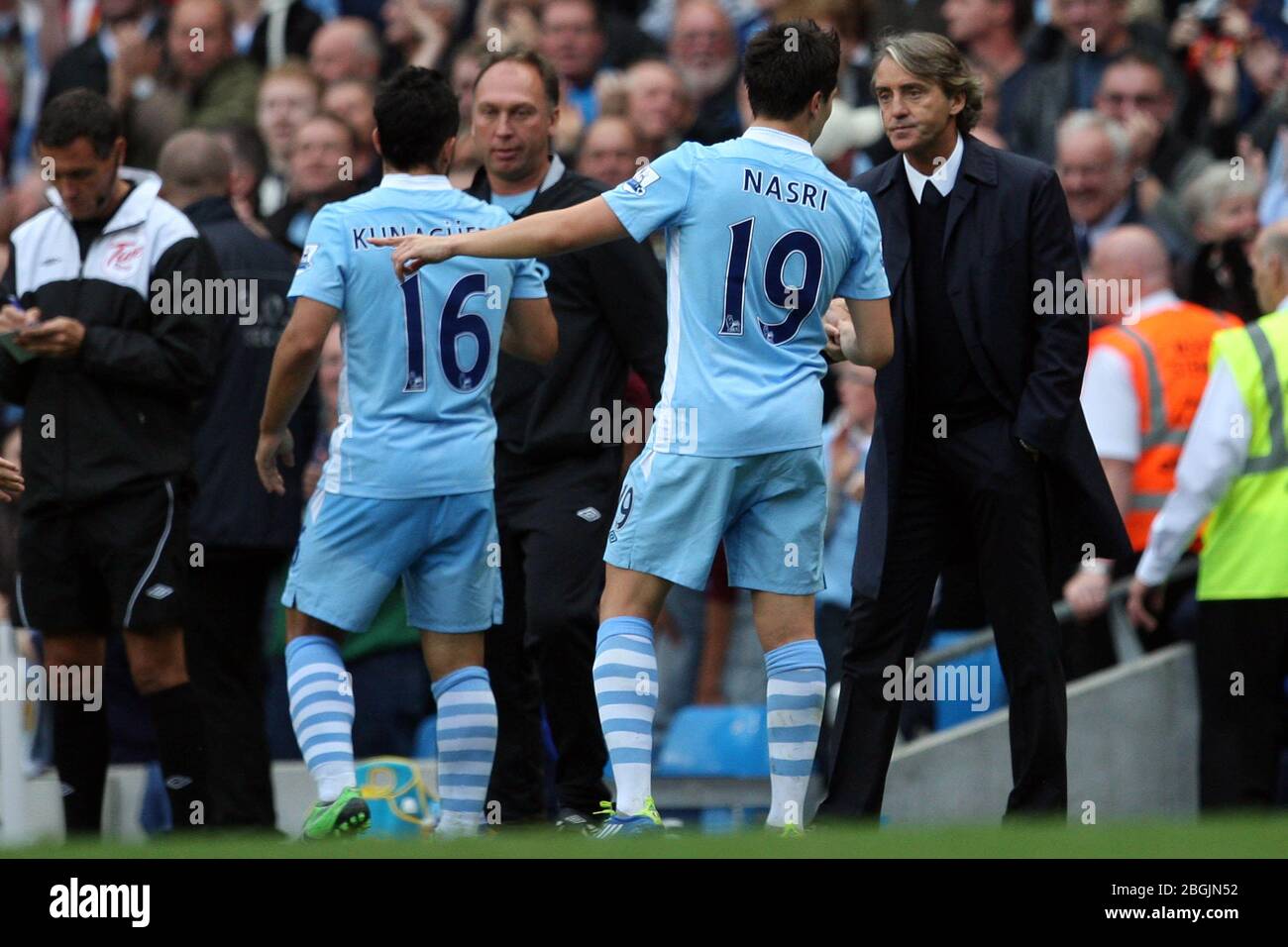 MANCHESTER, ENGLAND Manchester City manager Roberto Mancini gives instructions to Samir Nasri whilst David Platt converses with Sergio Aguero  during the Premier League match between Manchester City  and Everton at the Etihad Stadiun, Manchester on Saturday 24th September 2011. (Credit Eddie Garvey | MI News) Photograph may only be used for newspaper and/or magazine editorial purposes, license required for commercial use Stock Photo