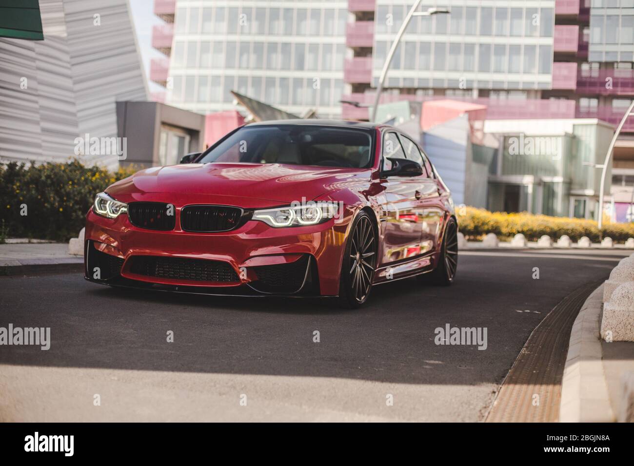 Red universal sedan in the business center Stock Photo - Alamy