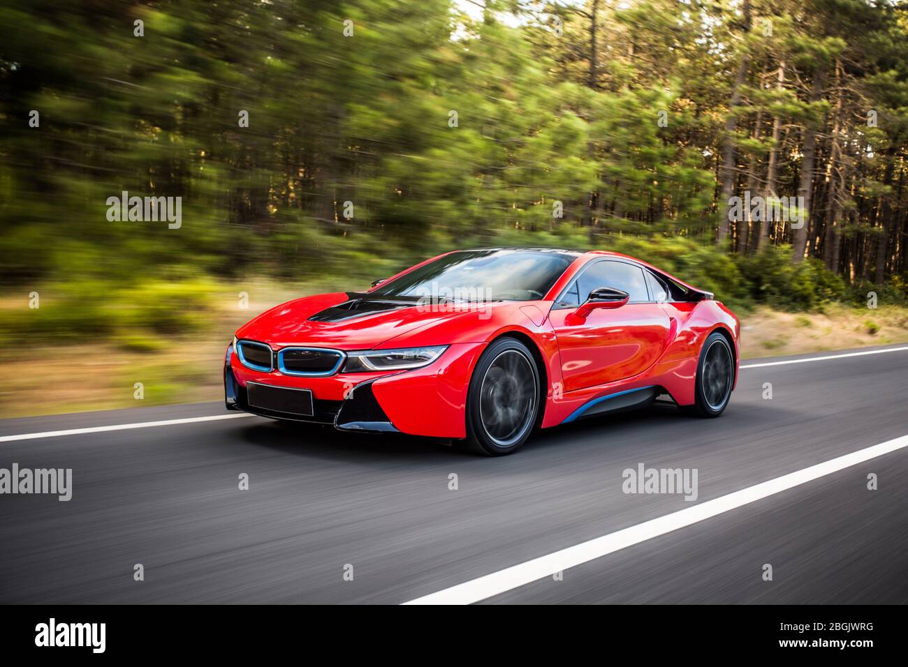 Red race car with black stripe on it in the forest Stock Photo Alamy