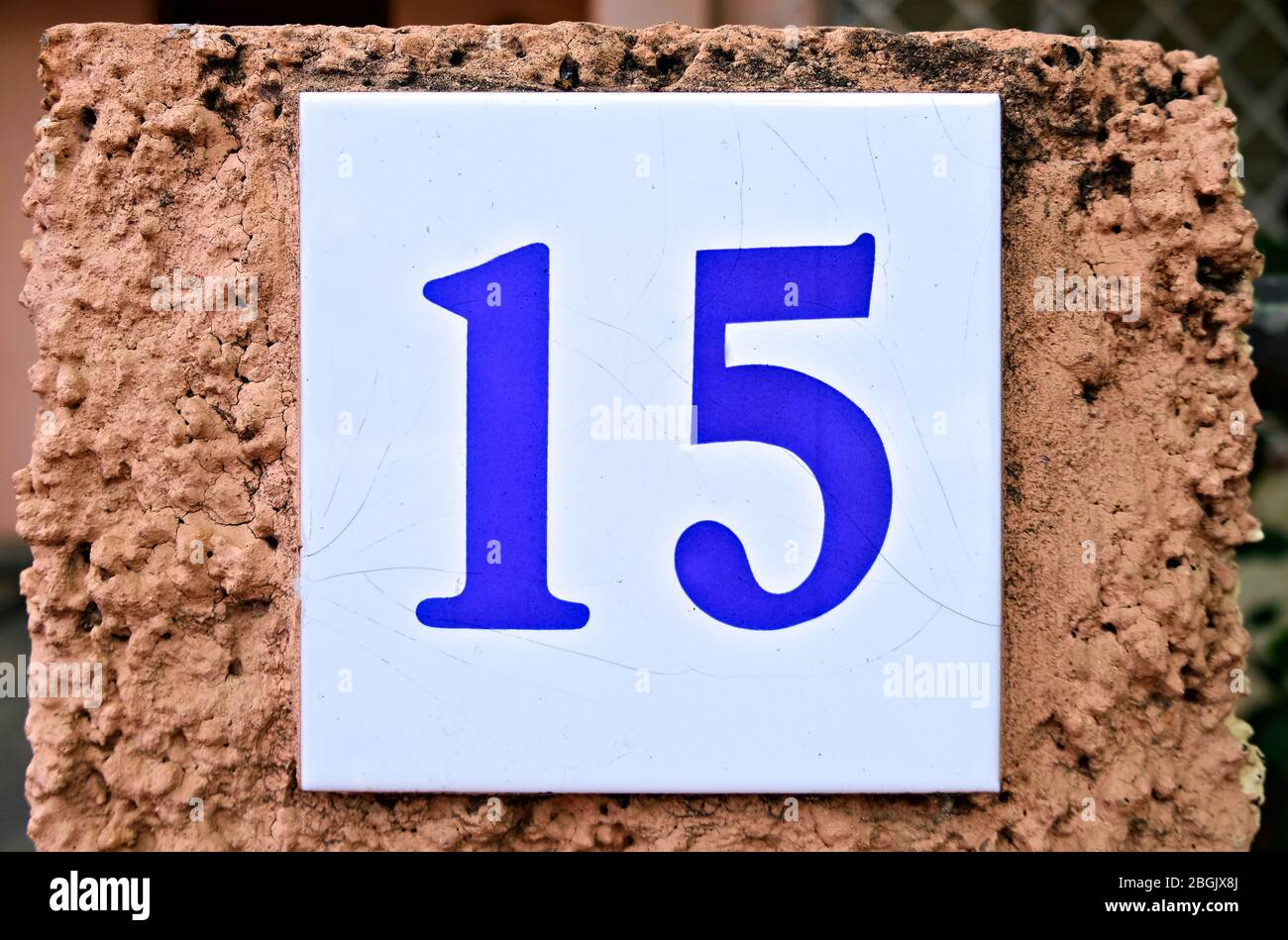 15, number fifteen, colorful tile on a wall. Stock Photo