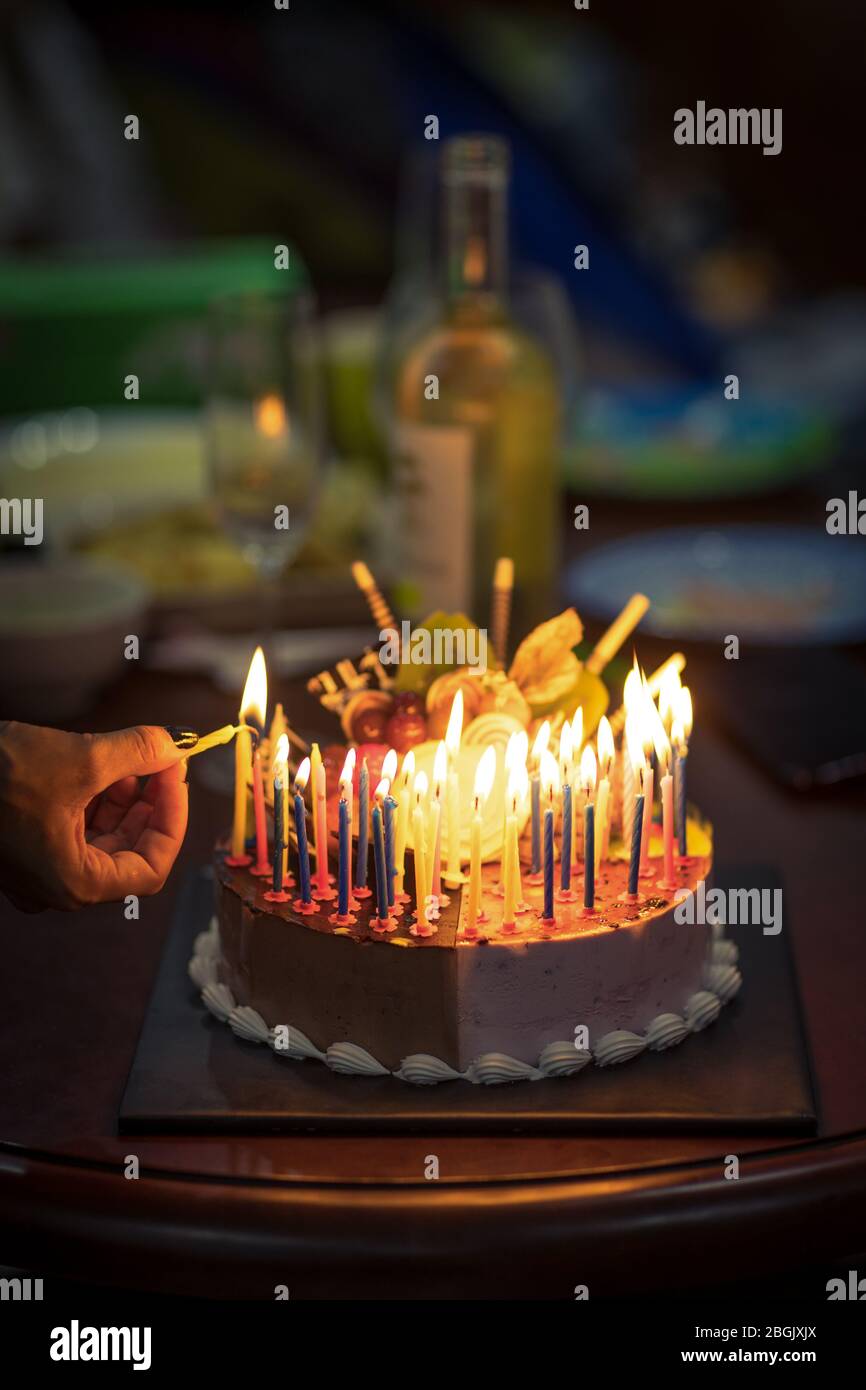 Birthday cake with candles in dark Stock Photo