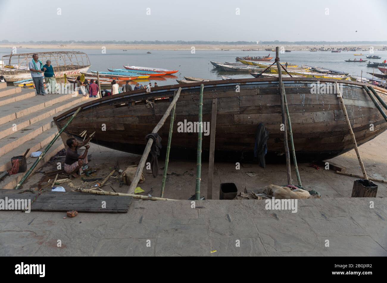 A shipwright builds a boat for a living near Ganges river bank in Varanasi, India Stock Photo