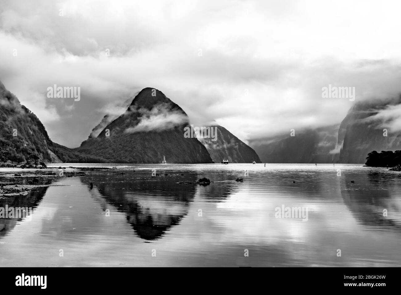 Dramatic scene and reflections of Mitre Peak at Milford Sound Fiordland New Zealand in the rain mist and low cloud Stock Photo
