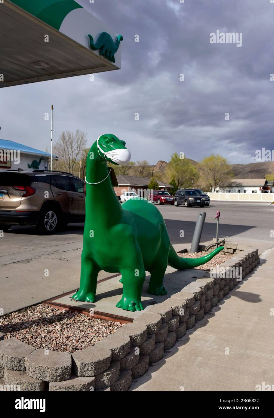 A Sinclair gas station dinosaur wearing a Covid-19 mask in Caliente, Nevada Stock Photo