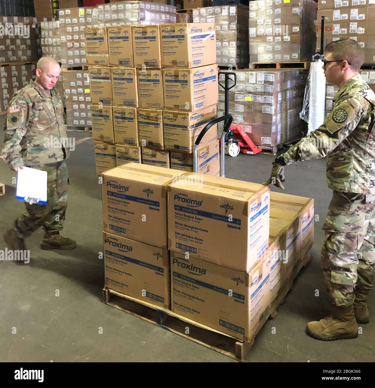 Soldiers from the Michigan National Guard assist Michigan Department of Health and Human Services with assembling and loading critical personal protective gear, such as gloves, gowns, and face shields, March 18, 2020. Once packaged, MDHHS will deliver the supplies to various local public health departments. (U.S. National Guard photo by Sgt. James Bennett) Stock Photo