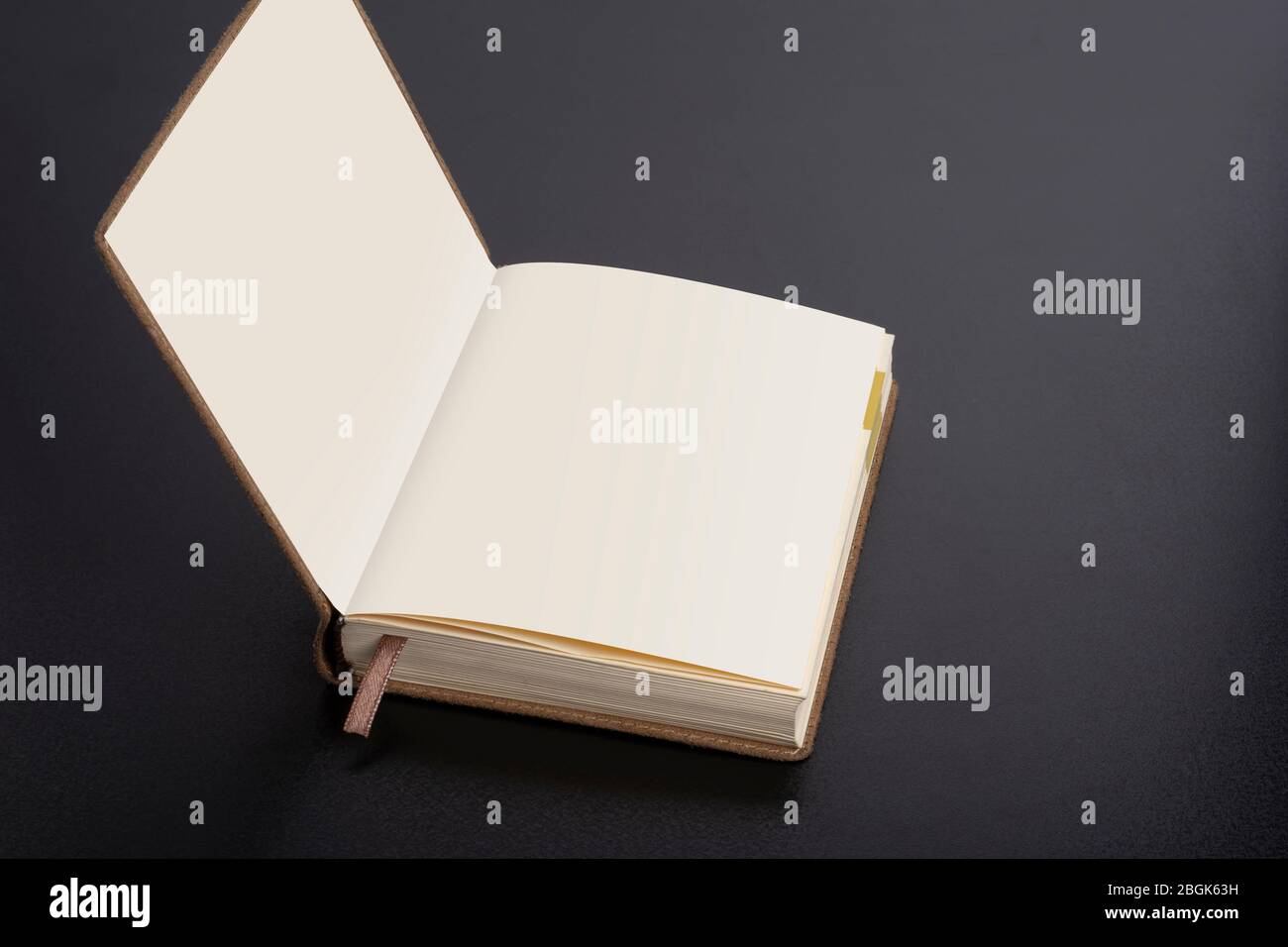 Daily planner notebook with smart object pages on dark black background Stock Photo