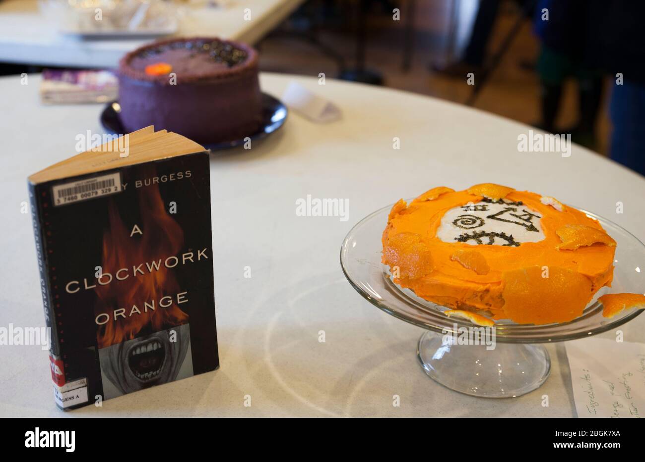 Library edible book competition submission is an orange decorated cake for Anthony Burgess's Clockwork Orange. Stock Photo