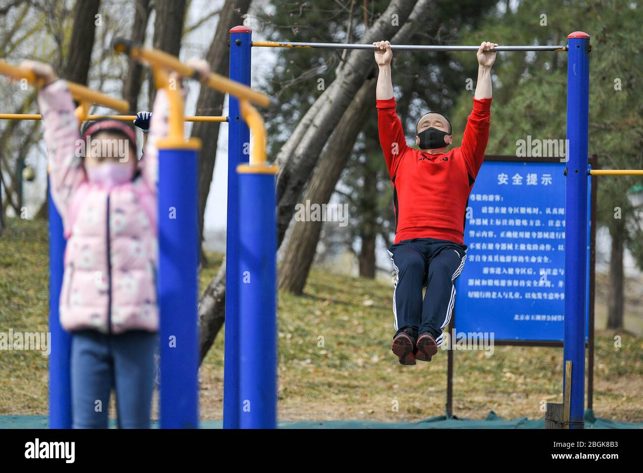 Citizens do exercise by jogging or with fitness equipment at a