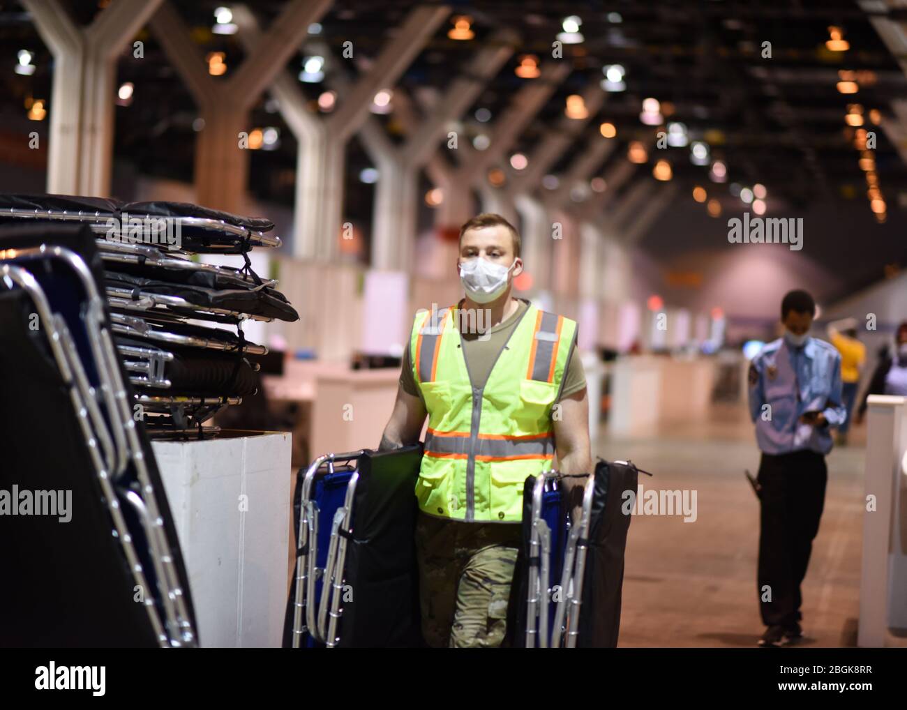 U.S. Air Force Senior Airman Jacob Taylor, from the 183d Wing, based at Springfield, Ill. removes cots from a wing dedicated to elderly patients to make room for more comfortable hospital beds at McCormick Place Convention Center in response to the COVID-19 pandemic in Chicago, April 13, 2020. Approximately 60 members of the Illinois Air National Guard were activated to support the U.S. Army Corps of Engineers and the Federal Emergency Management Agency (FEMA) to temporarily convert part of the McCormick Place Convention Center into an Alternate Care Facility (ACF) for COVID-19 patients with m Stock Photo