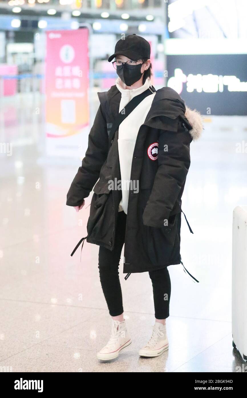Chinese actress Li Gengxi arrives at a Beijing airport before departure ...