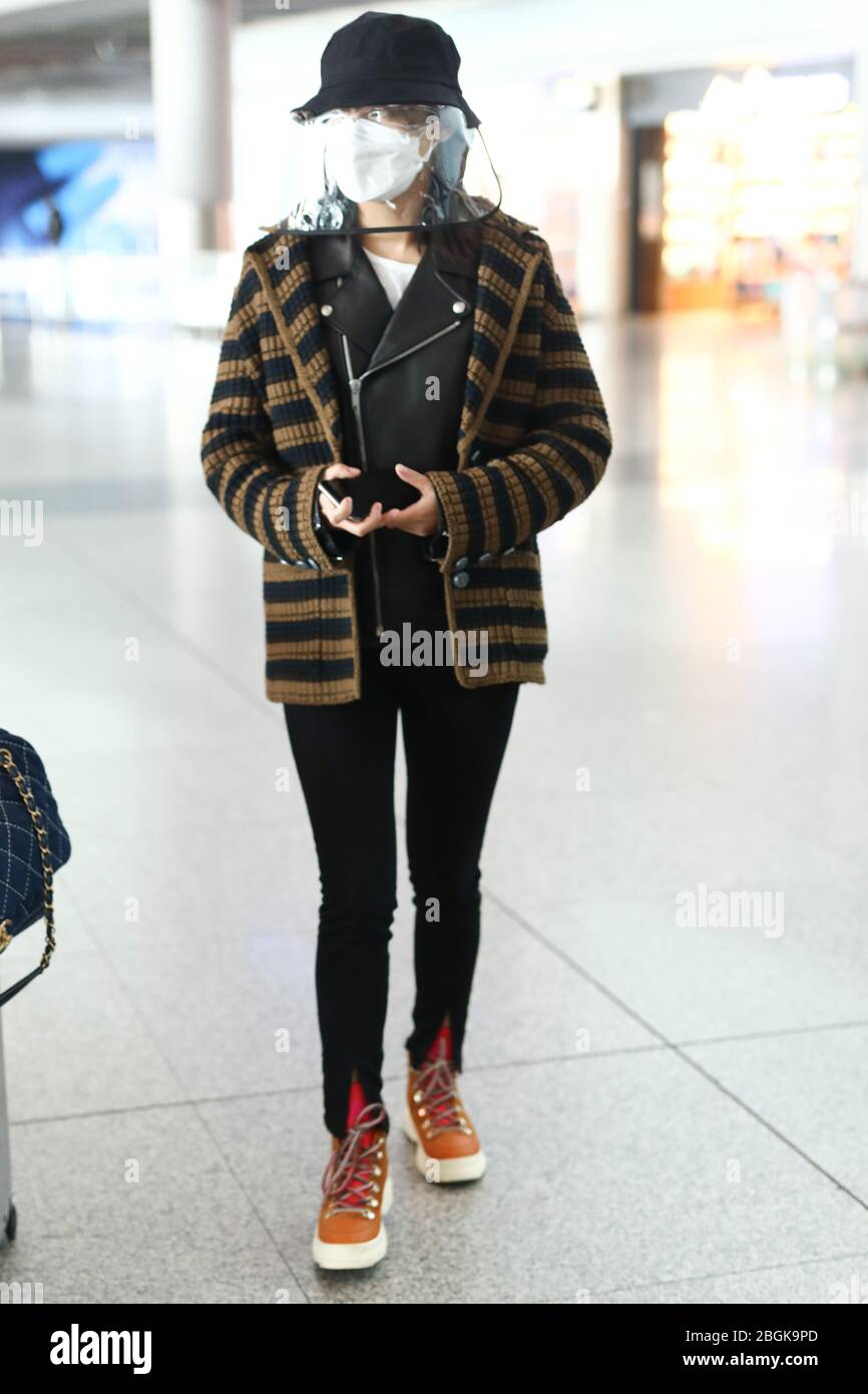 Chinese actress Xin Zhilei arrives at a Beijing airport after landing ...
