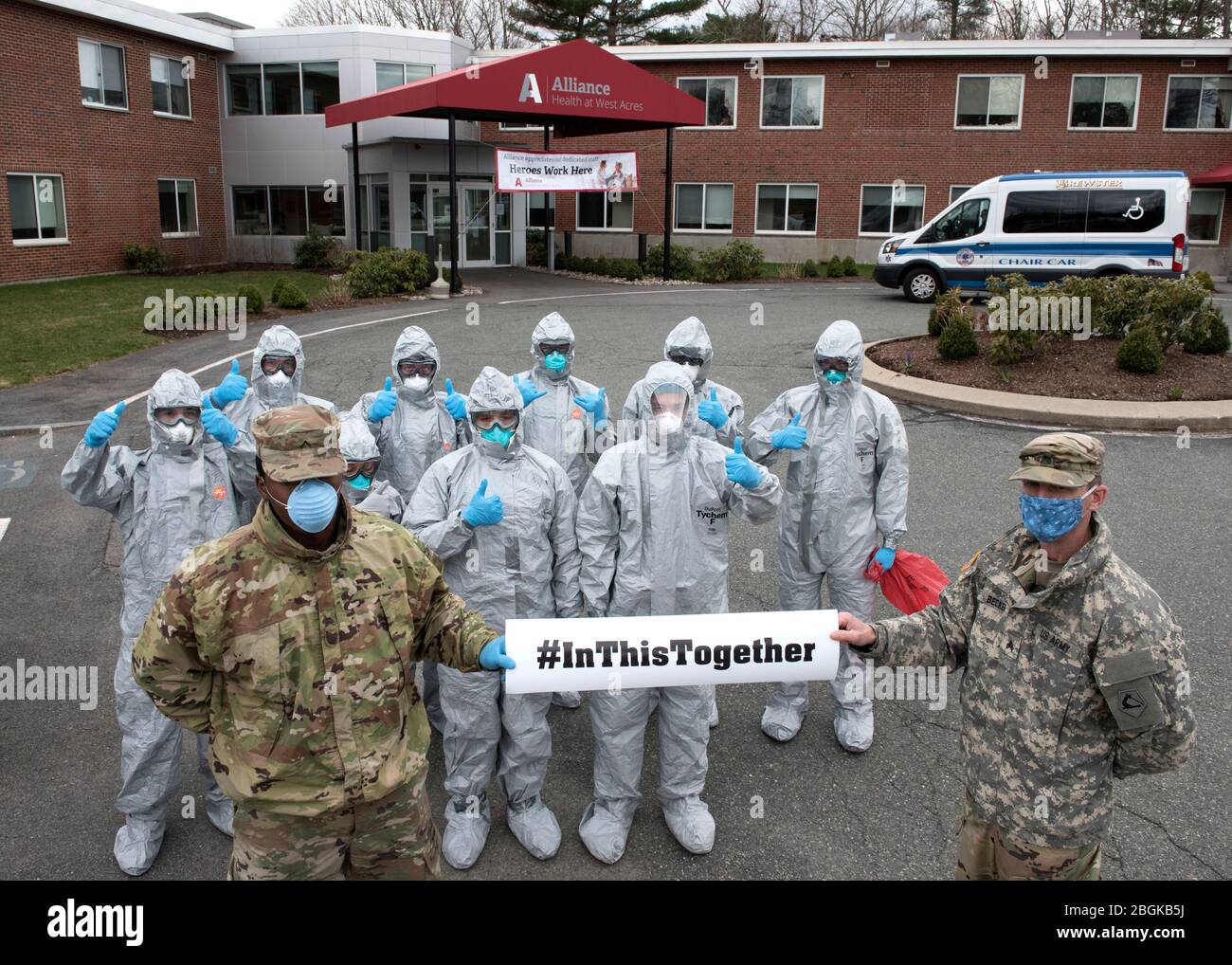 Soldiers and Airmen from the Massachusetts National Guard gather together prior to completing COVID-19 testing on residents at the Alliance at West Acres nursing home, Brockton, Mass., April 10, 2020. Twelve medical teams are activated throughout the state and are conducting COVID-19 testing at medical facilities and nursing homes with high-risk populations. Homes and providers are identified by the Department of Public Health and Human Services for testing. This mission is one of several operations across the commonwealth in support of coronavirus response efforts. (U.S. Air National Guard ph Stock Photo