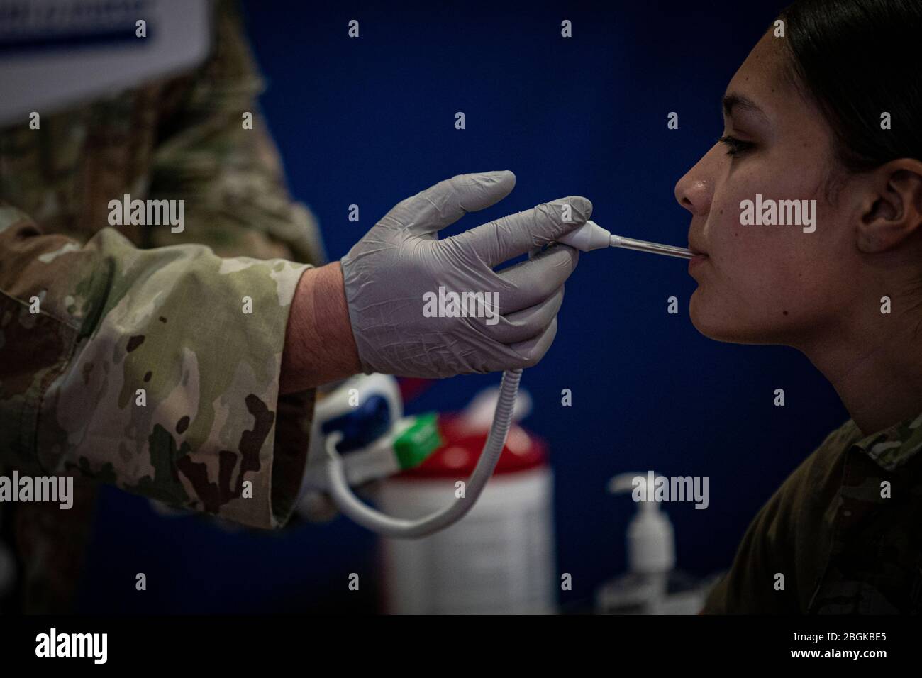 A New Jersey Army National Guard Soldier with the 143rd Transportation Company has her temperature checked during medical screening for state activation at the Teaneck Armory in Teaneck, N.J., March 19, 2020. The New Jersey National Guard has more than 150 members activated to support state and local authorities during the COVID-19 outbreak. Bother the 508th and 143rd will be working with the New Jersey Department of Health and local first responders at a mobile testing facility located at Bergen Community College in Paramus, N.J. (U.S. Air National Guard photo by Master Sgt. Matt Hecht) Stock Photo
