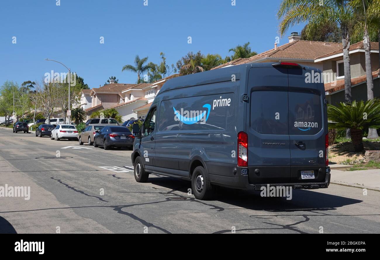 Amazon Prime delivery van out on deliveries in suburban neighborhood. Stock Photo