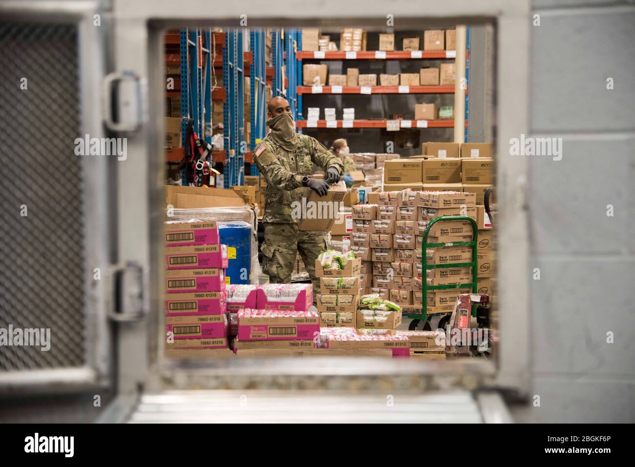 An Indiana National Guard soldier from the 38th Sustainment Brigade, Indiana prepares items to fulfill commissary orders for Indiana offenders at the Plainfield Correctional Facility, Plainfield, Indiana on April 14, 2020. Troops were recently activated to assist the Indiana Department of Correction with warehouse operations after limitations to the correctional industries were caused by the COVID-19 pandemic. (U.S. Air National Guard photo by Staff Sgt. Justin Andras) Stock Photo