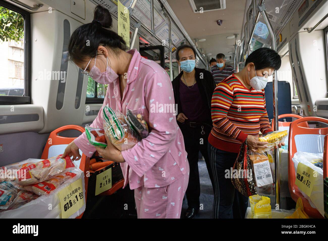 Residents purchase at the bus supermarket, which is a cooperation of ...