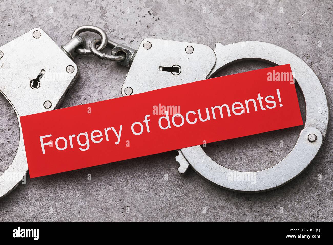 Note with text and handcuffs, top view. The concept of punishment for falsification of documents Stock Photo