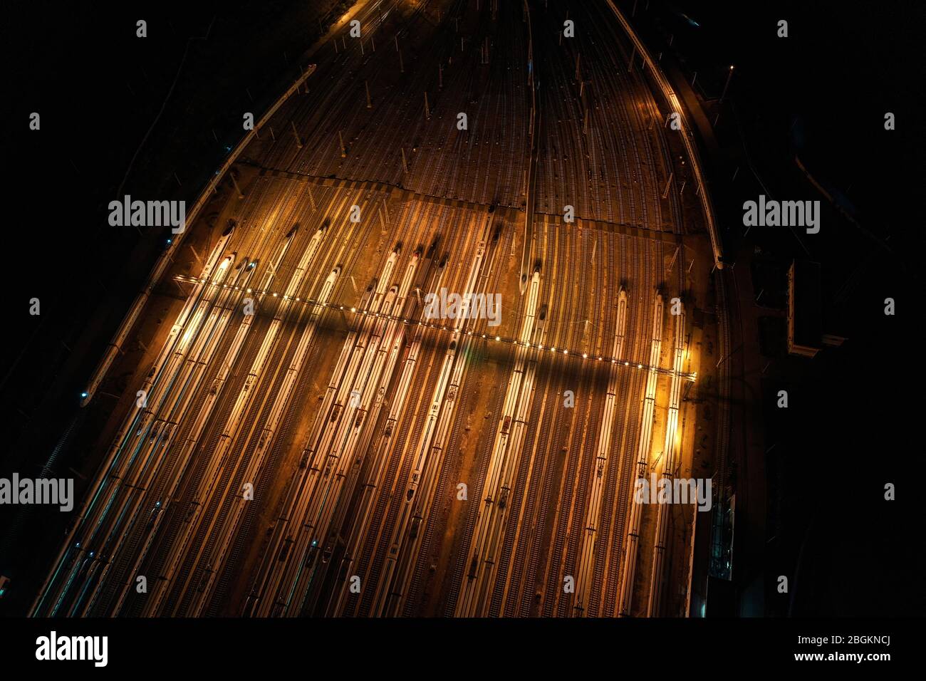 An aerial view of high-speed trains gathering at night after ...