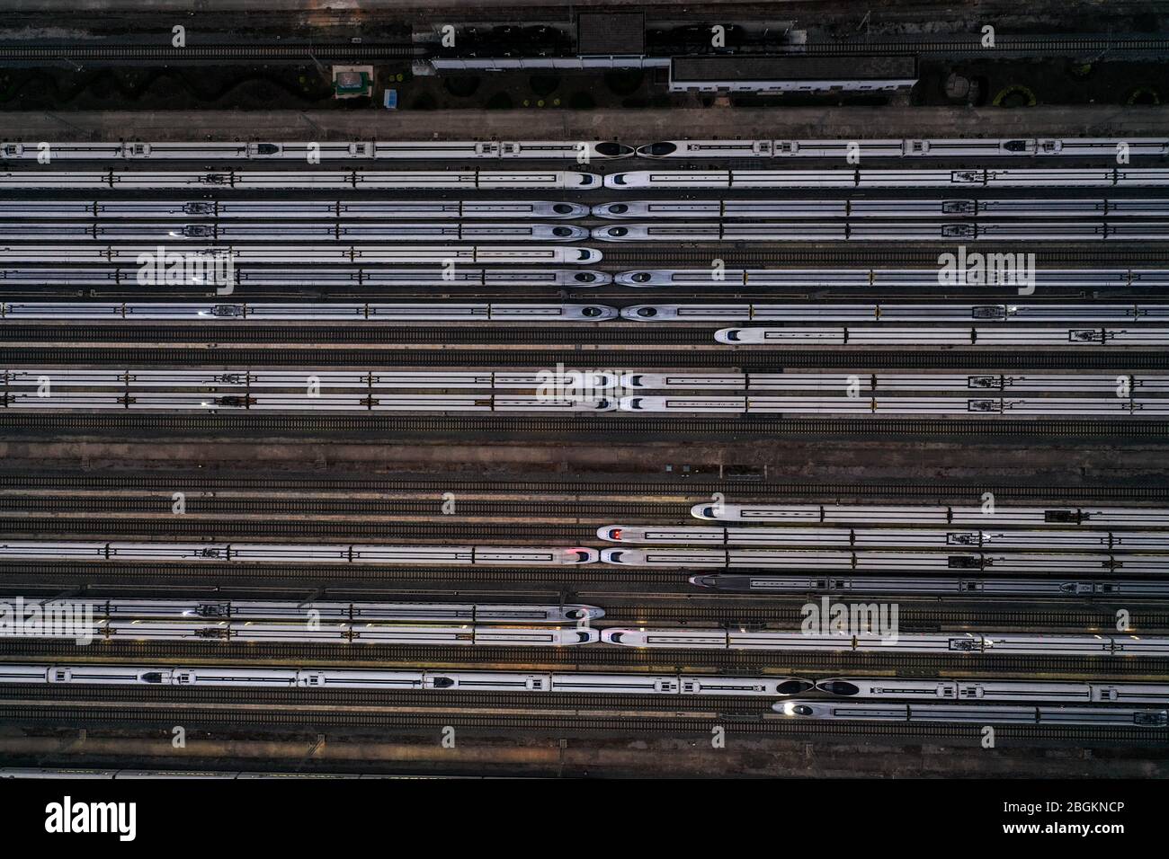 An aerial view of high-speed trains gathering at night after ...