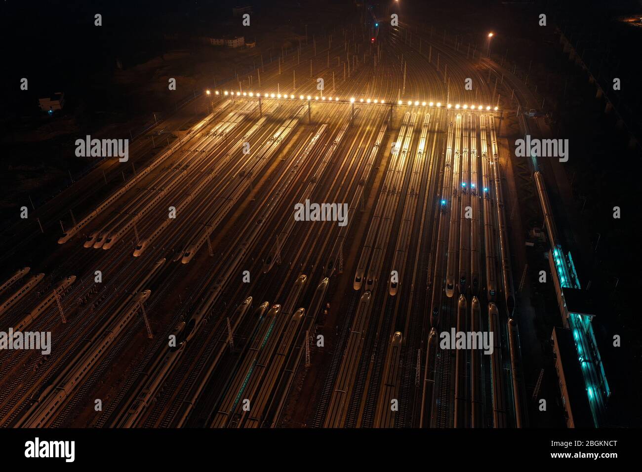 An aerial view of high-speed trains gathering at night after ...