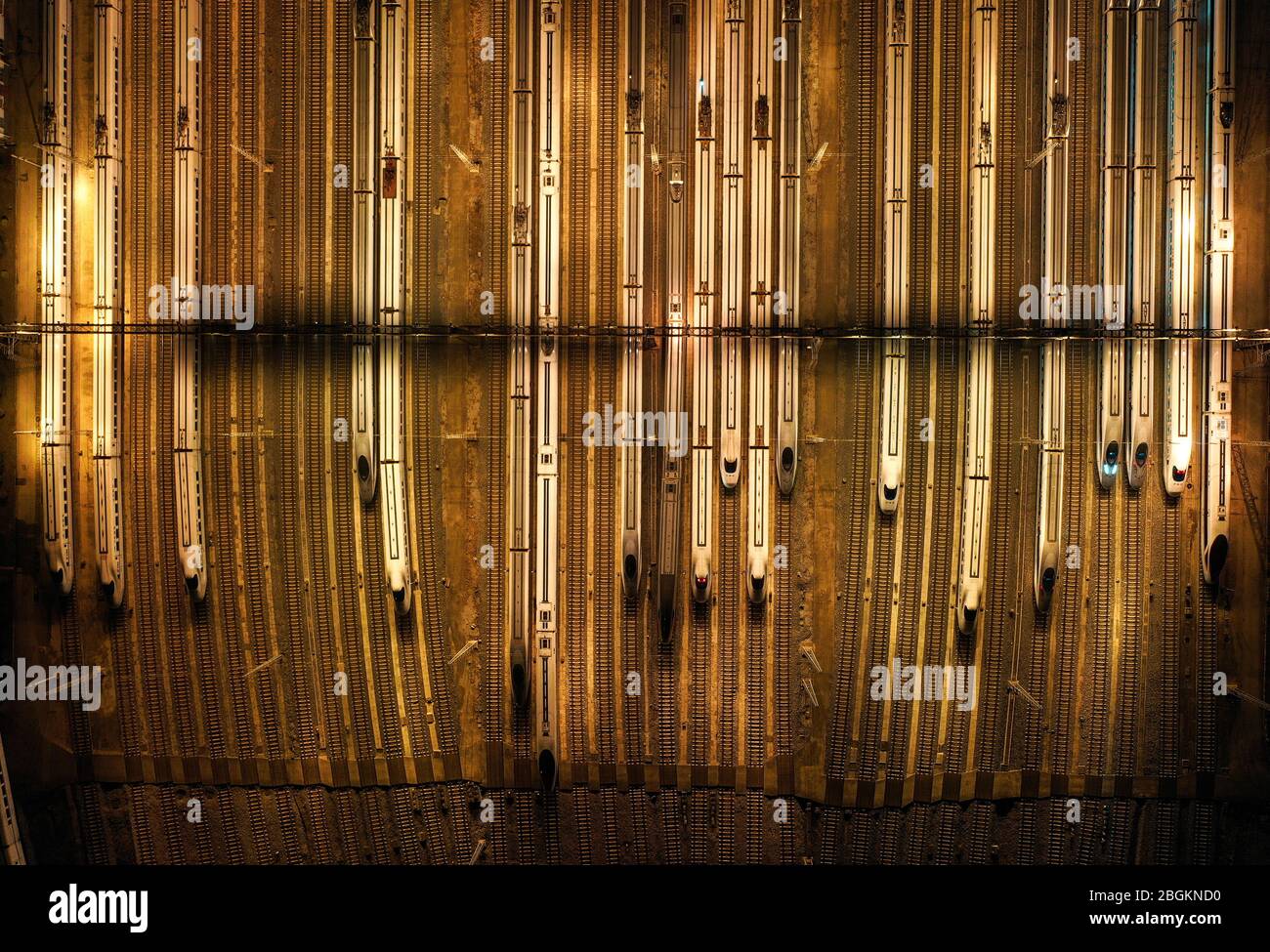 An aerial view of high-speed trains gathering at night after ...