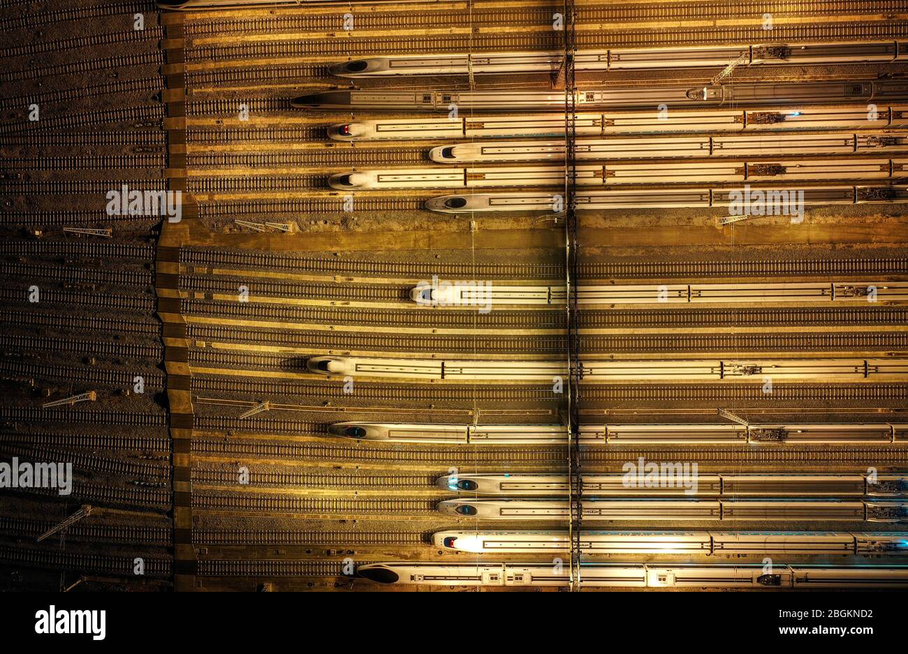 An aerial view of high-speed trains gathering at night after ...