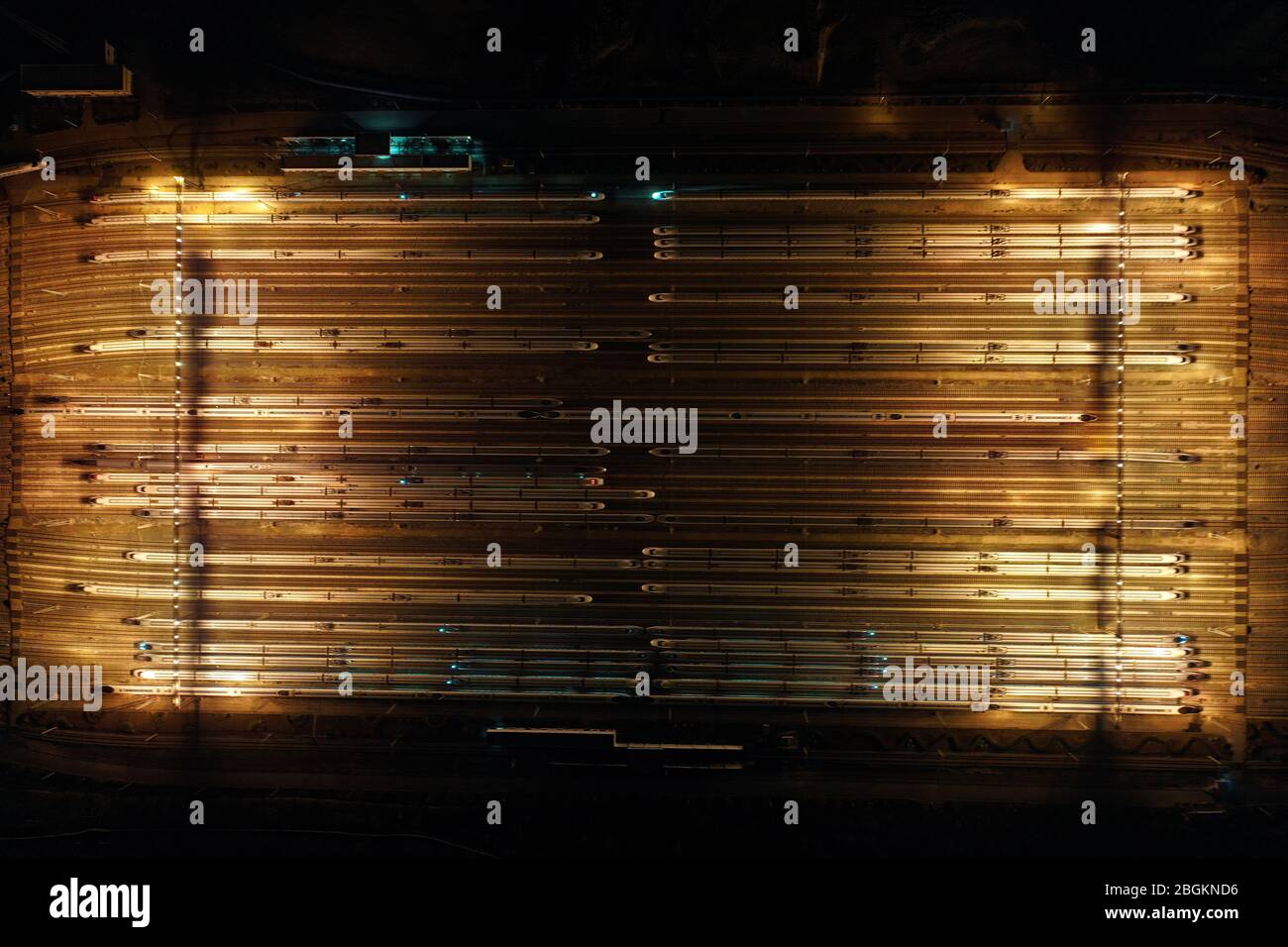 An aerial view of high-speed trains gathering at night after ...
