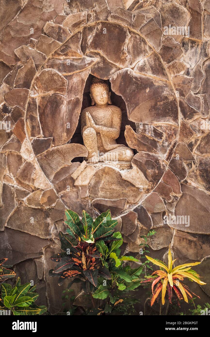 Statue of a Balinese woman and tropical foliage, Bali, Indonesia Stock Photo