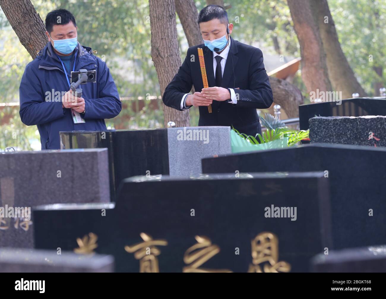 A staff of a local cemetery does online tomb sweeping and worshiping to memorize the deceased