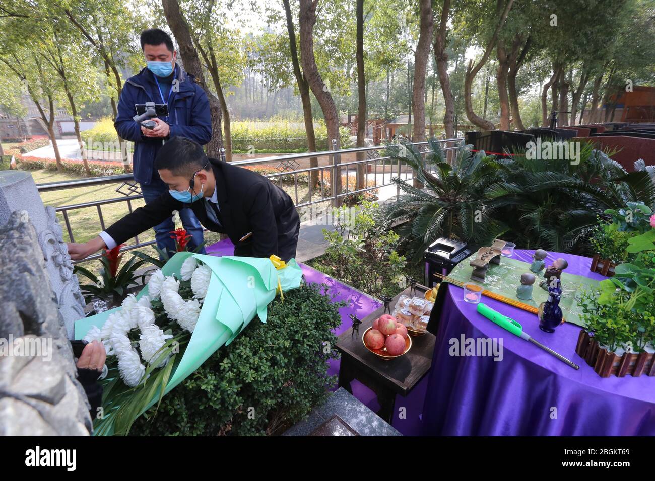 A staff of a local cemetery does online tomb sweeping and worshiping to memorize the deceased