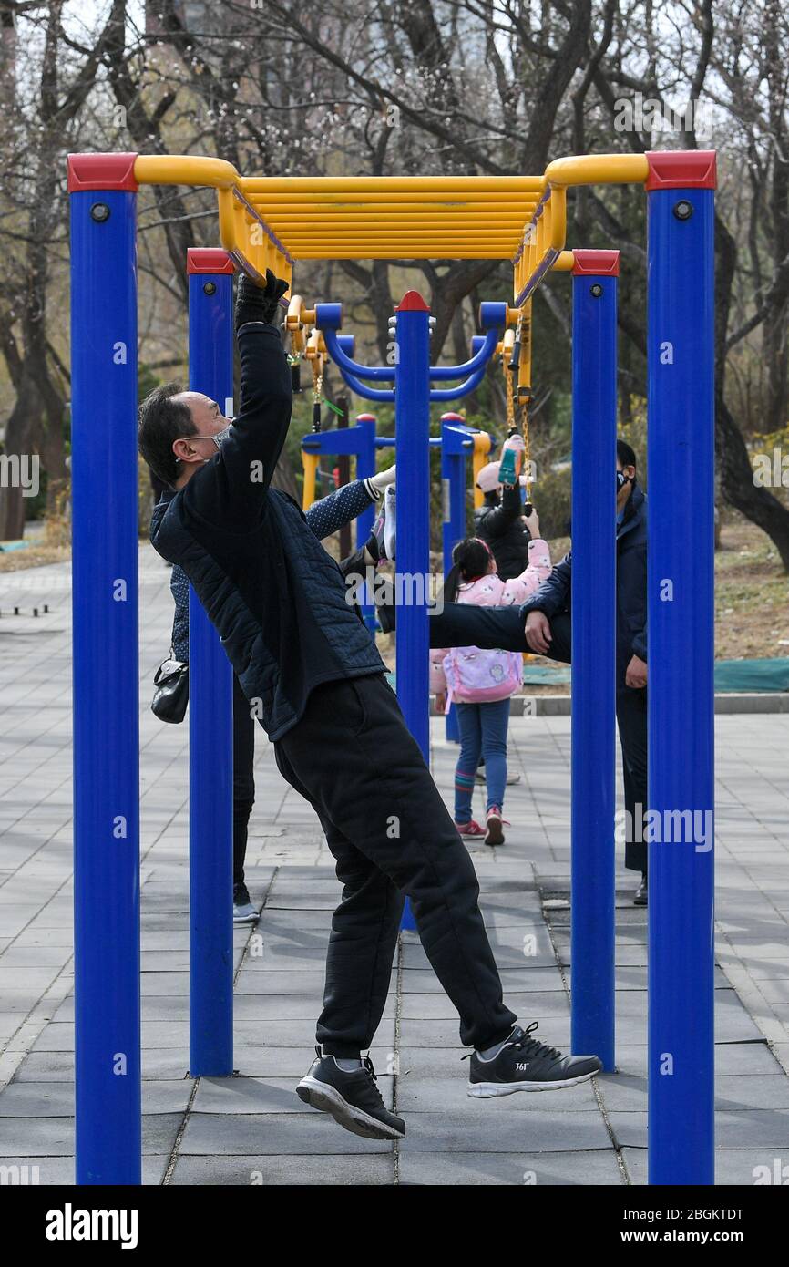 Citizens do exercise by jogging or with fitness equipment at a