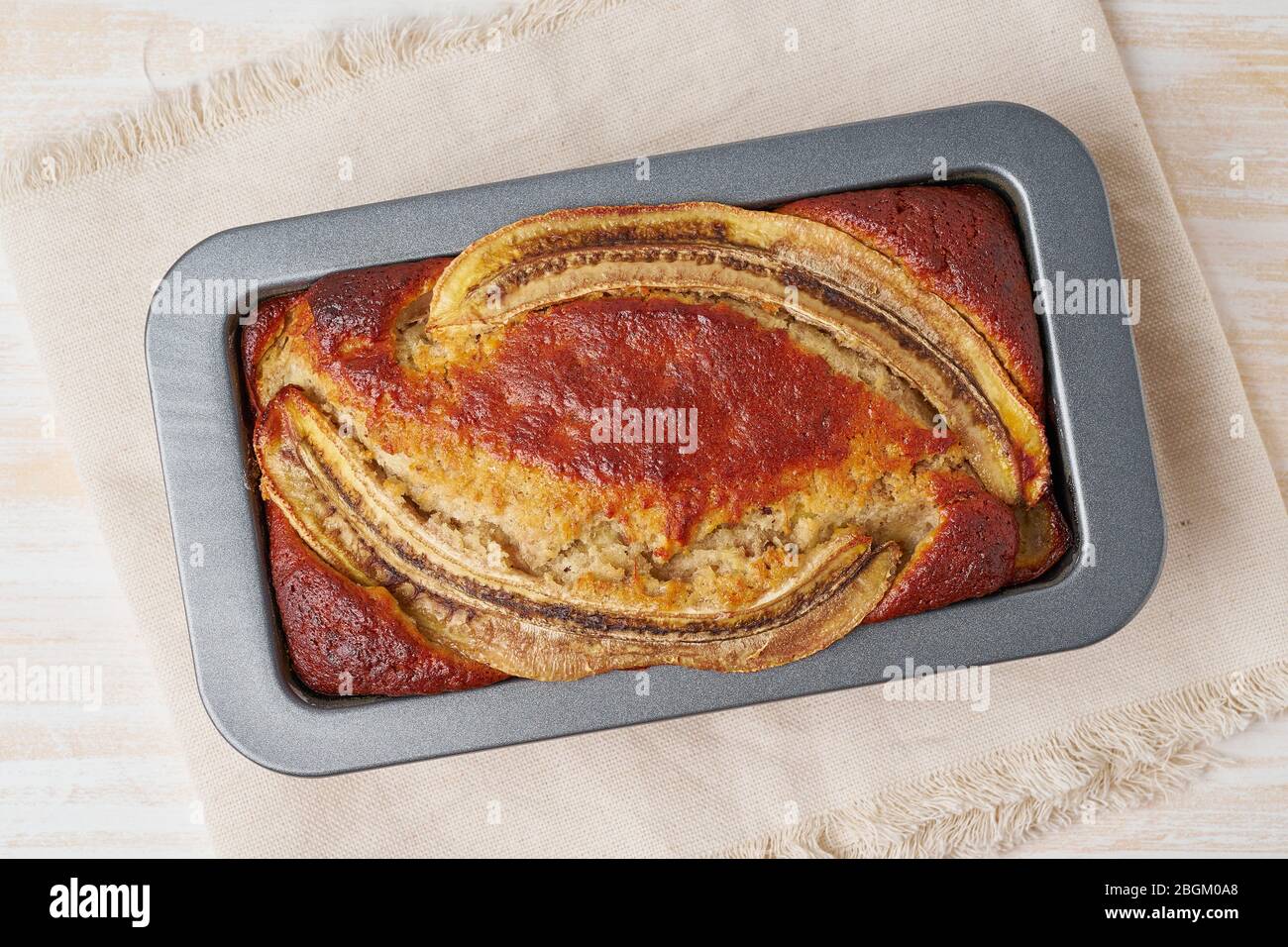 Banana bread in a pan. Cake with banana, chocolate, walnut. Traditional