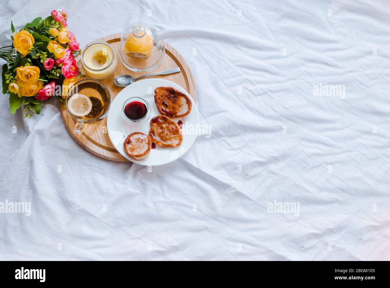 Breakfast in bed. Homeliness. Lemon tea close-up. Place for text Stock Photo