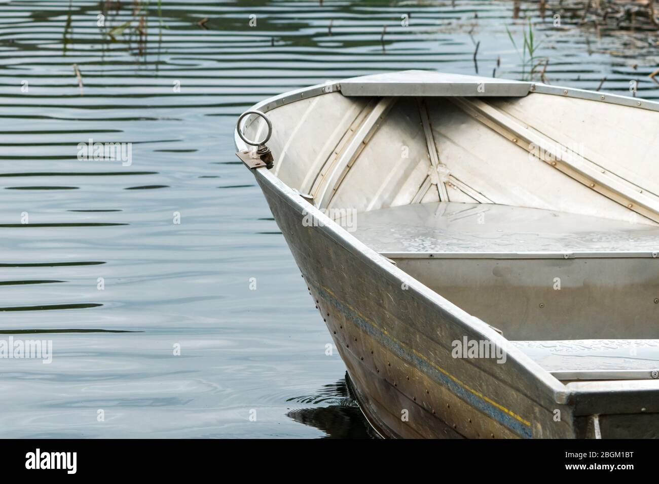 Aluminium or aluminum row boat close up on water, lake, river with ripples  and grass reeds concept Summer fun, recreation and leisure activity Stock  Photo - Alamy