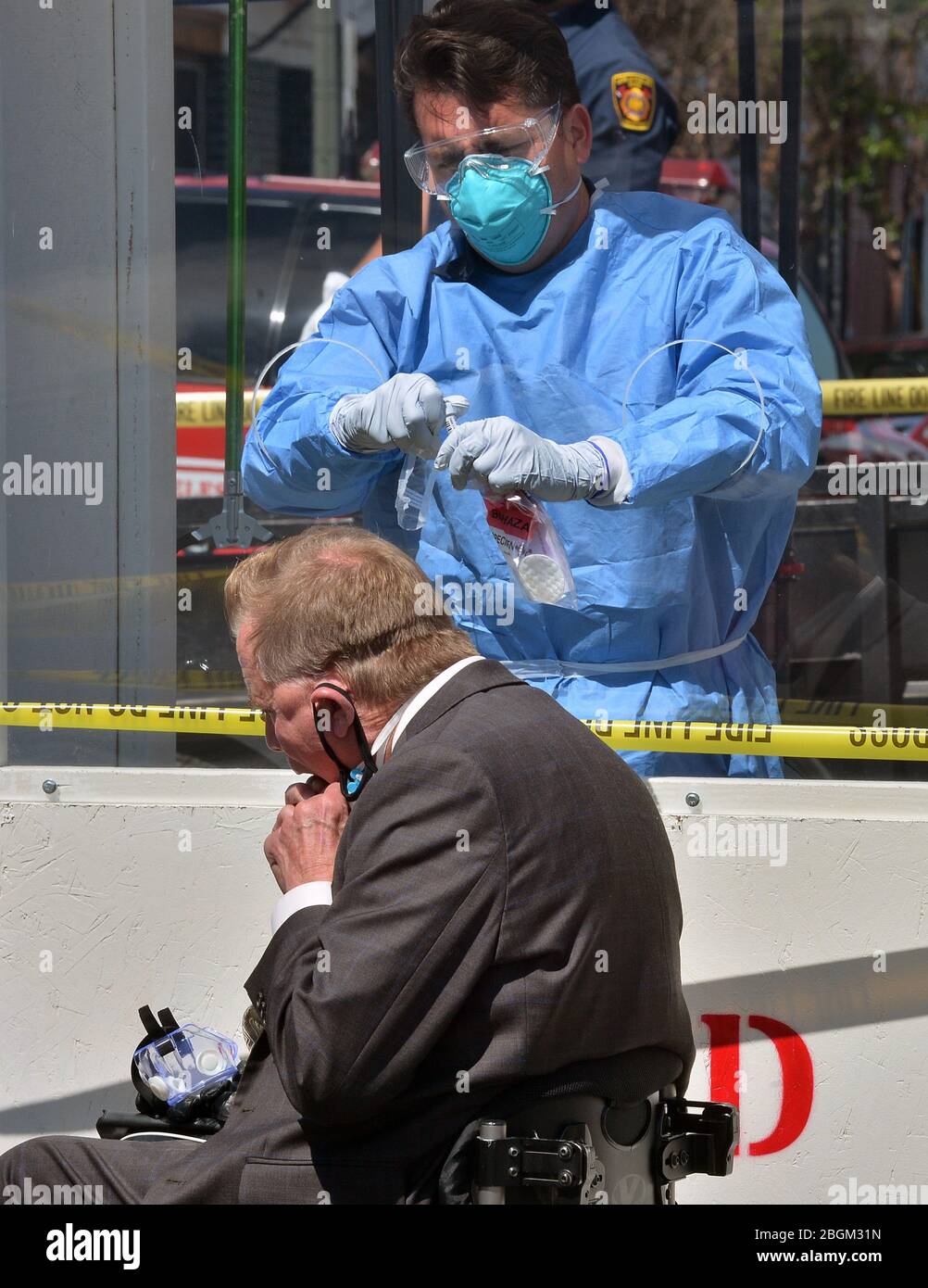 Union Rescue Mission CEO Rev. Andy Bales administers a COVID-19 self-testing kit at a LA Fire Department pop-up testing station, where workers in hazmat suits handed out testing swabs to the homeless from behind a protective window in the Skid Row section of Los Angeles on Tuesday, April 21, 2020. Forty-three more people have tested positive for the coronavirus at the Union Rescue Mission, Los Angeles' oldest and largest homeless shelter. The sudden spike in cases comes despite the extreme precautions the shelter has been taking to prevent such an outbreak. Photo by Jim Ruymen/UPI Stock Photo