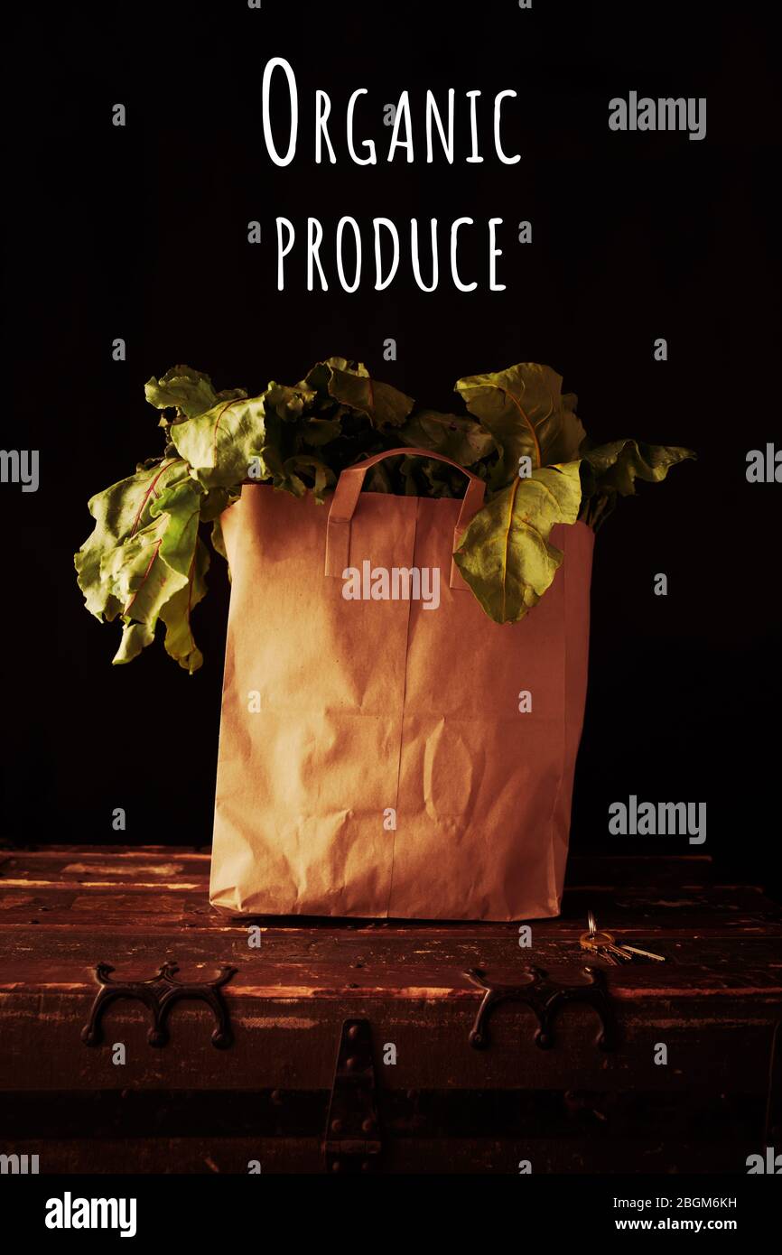 Paper bag with beet greens, with organic produce wording. Concept of