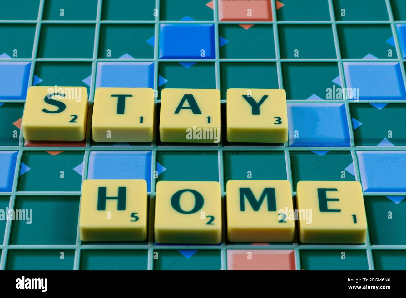 Stay Home on the word game board in coronavirus quarantine days Stock Photo