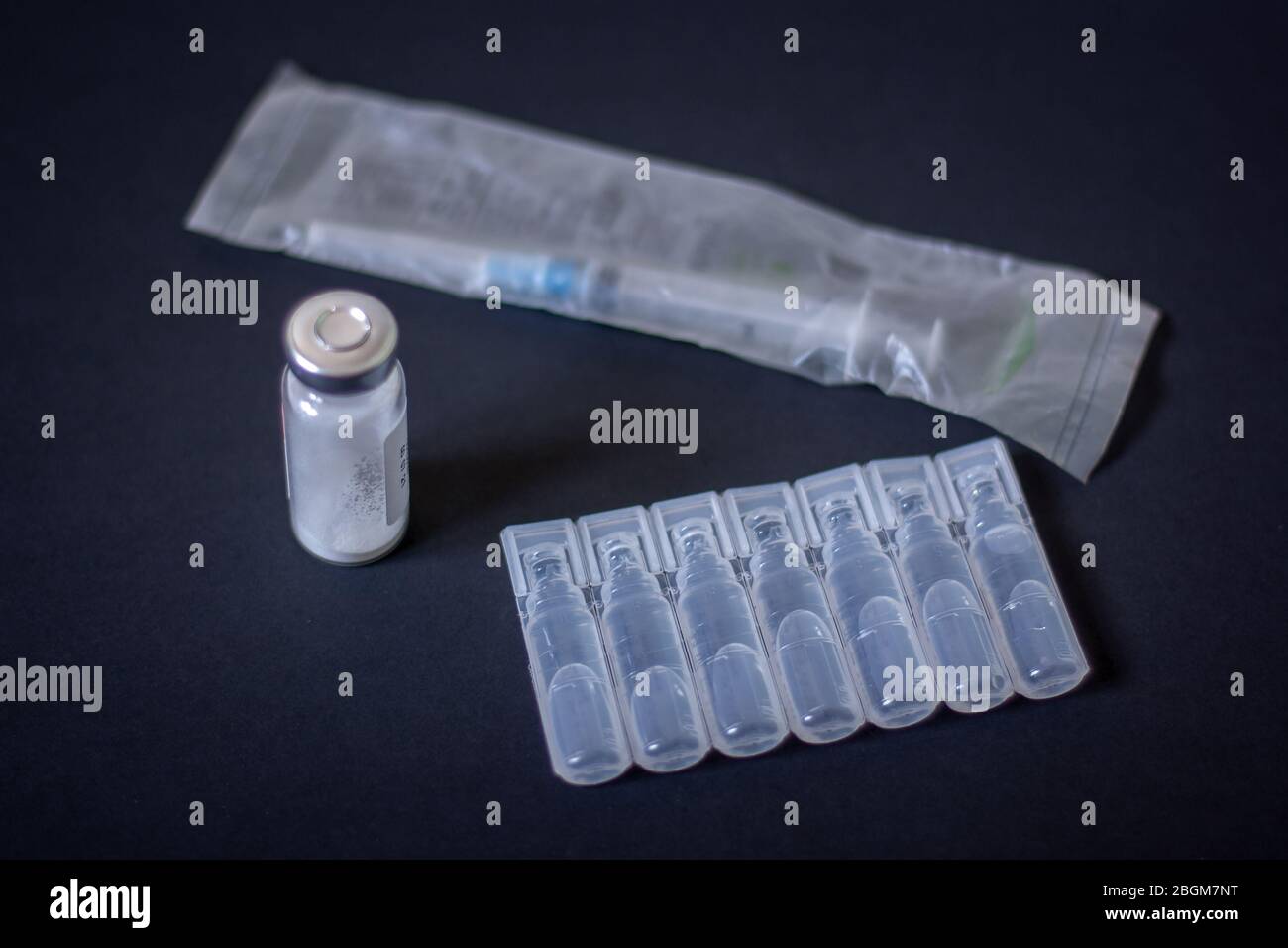 Packaging of plastic ampoules, a bottle with white powder and a