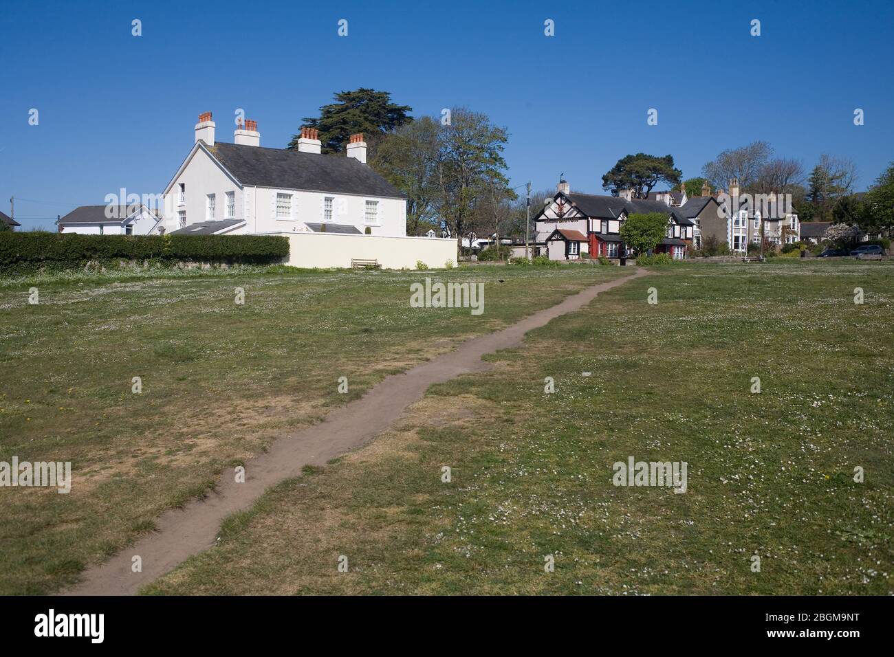 Newton village green in Porthcawl and a sunny spring morning with Crown house on the left and the temporarily closed Ancient Briton pub Stock Photo