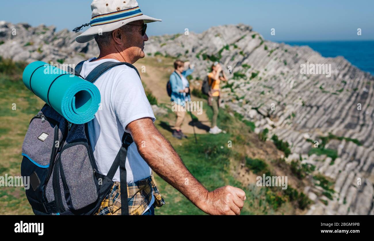 Senior man trekking looking at the landscape Stock Photo