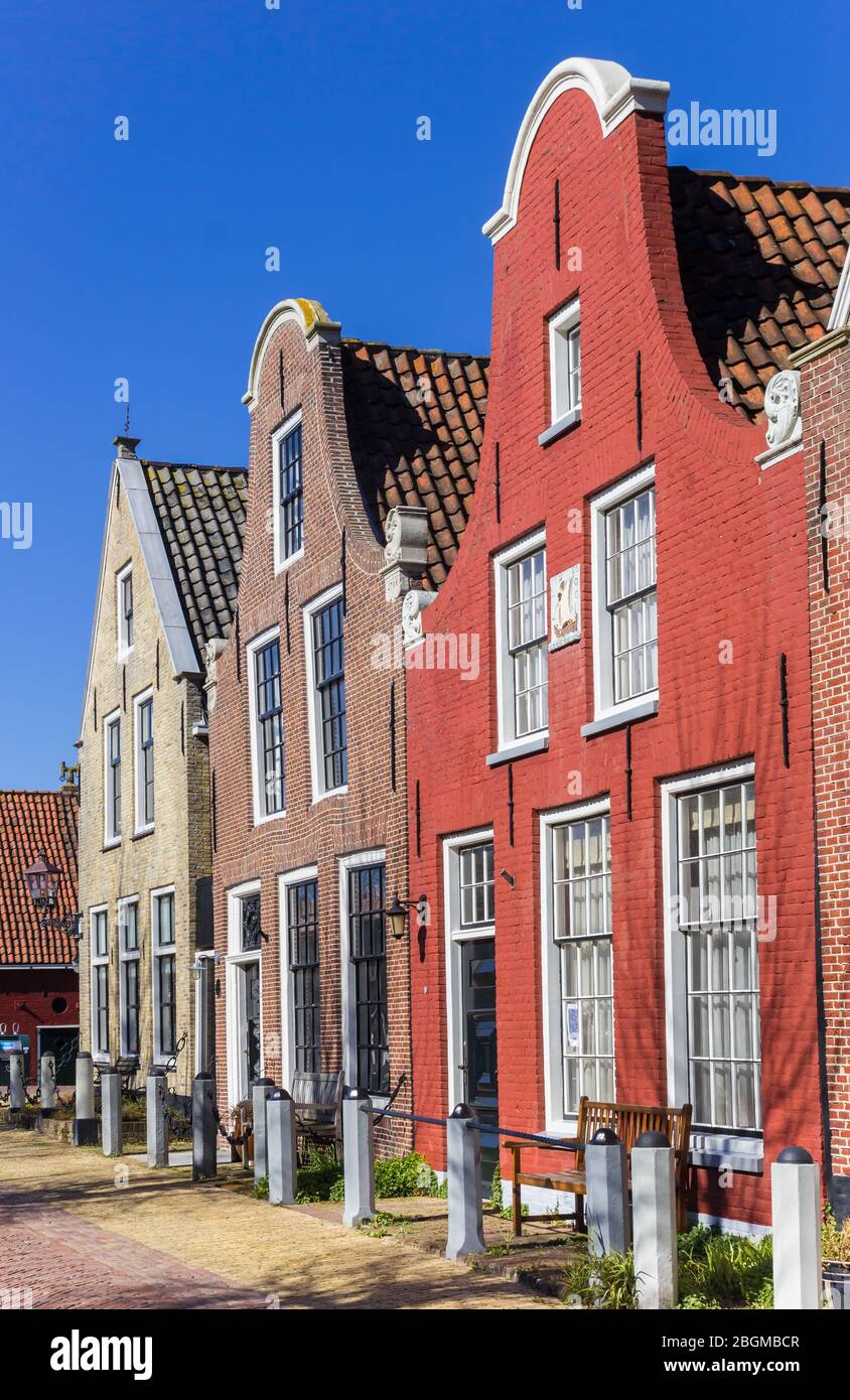 Red brick house with clock gable in Harlingen, Netherlands
