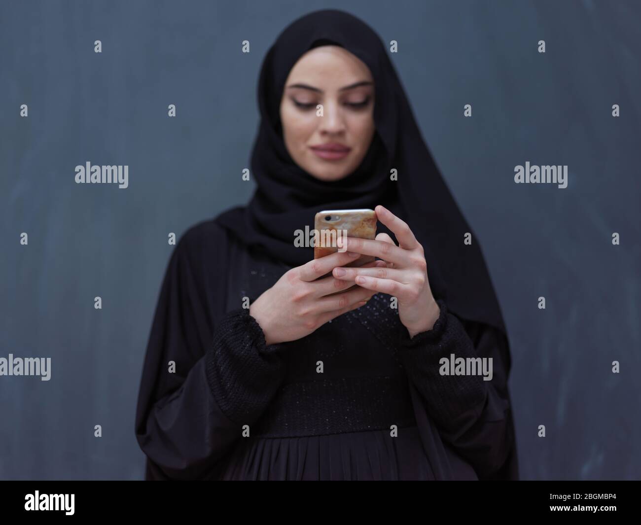 young modern muslim business woman using smartphone wearing hijab ...