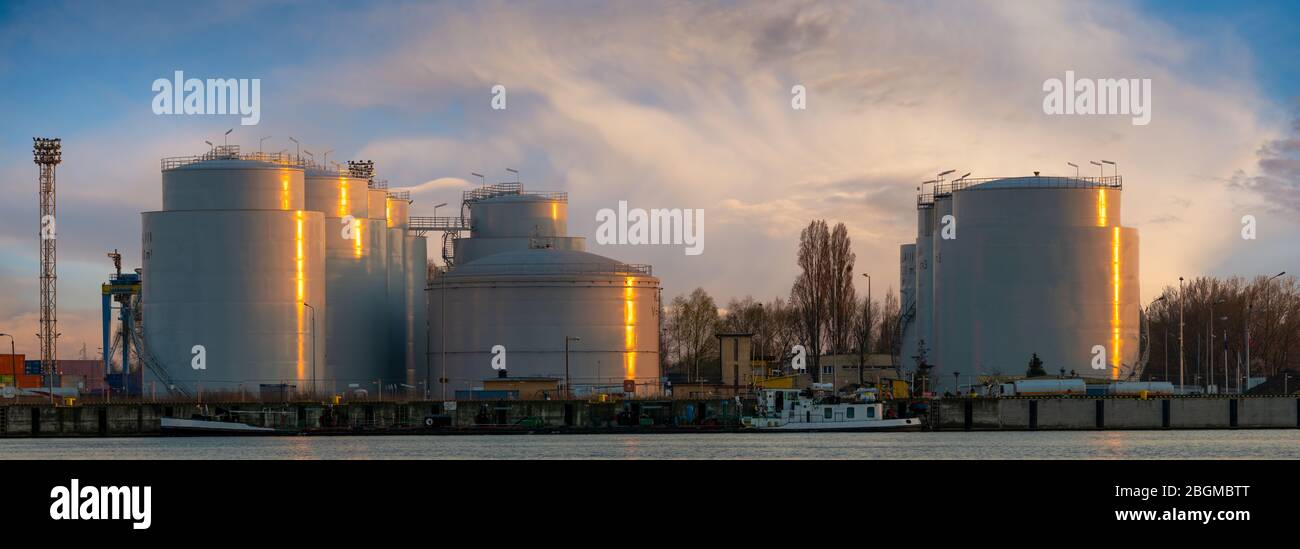 fuel tanks in the fuel warehouse in the light of the setting sun