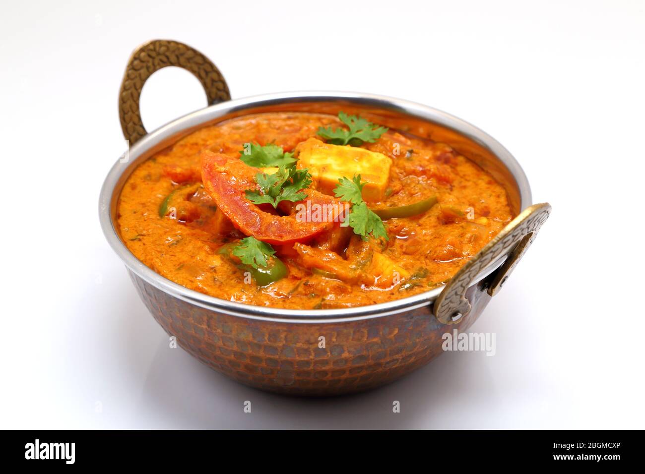 Indian Food or Indian Curry in a copper brass serving bowl. Stock Photo