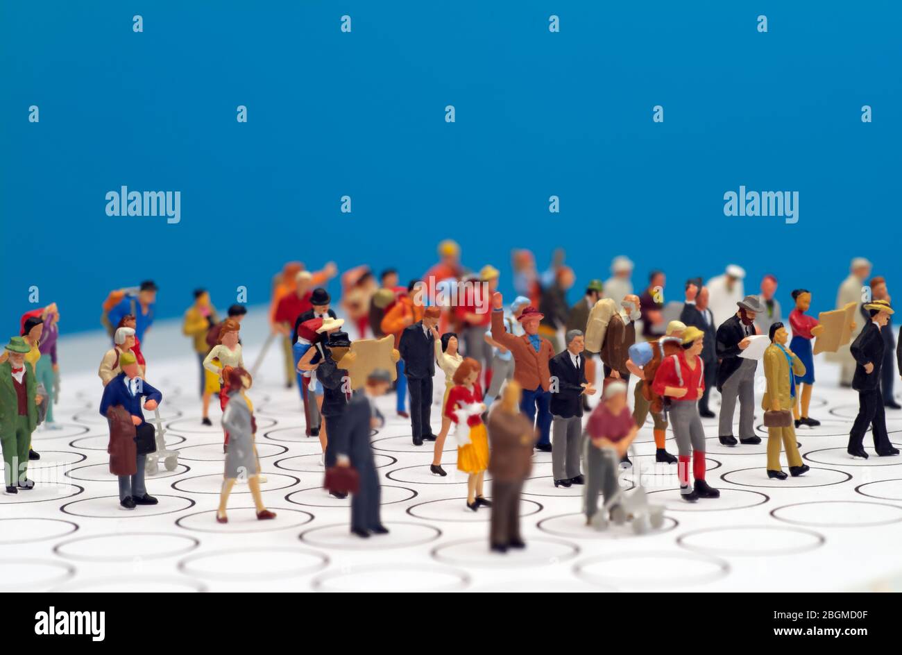 Miniature toys - social distancing conceptual image, people distancing each other in public places to avoid infection. Stock Photo