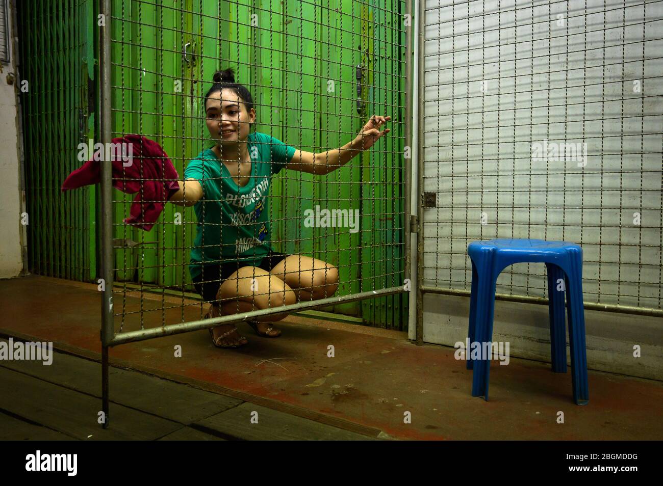 A Thai woman cleaning up a market stall, Bangkok, Thailand Stock Photo