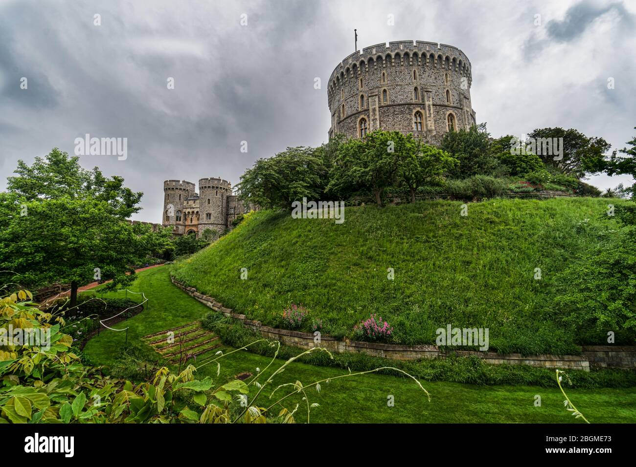 Windsor Castle and its garden with a dramatic sky background. Windsor Castle is a royal residence at Windsor in the English county of Berkshire near L Stock Photo